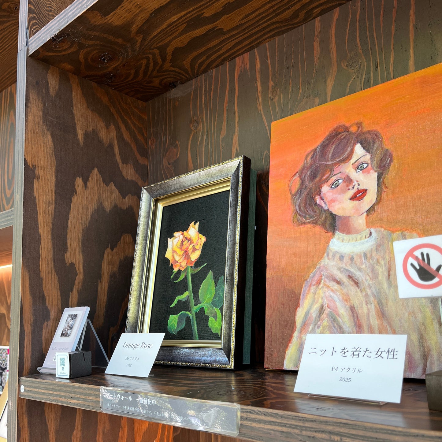 図書館兼コンサートホールの展示スペースでの作品展示の様子。落ち着いた雰囲気の中でアートが映える空間。
Exhibition view of artworks displayed in a library and concert hall space. A calm and elegant atmosphere highlighting the art.