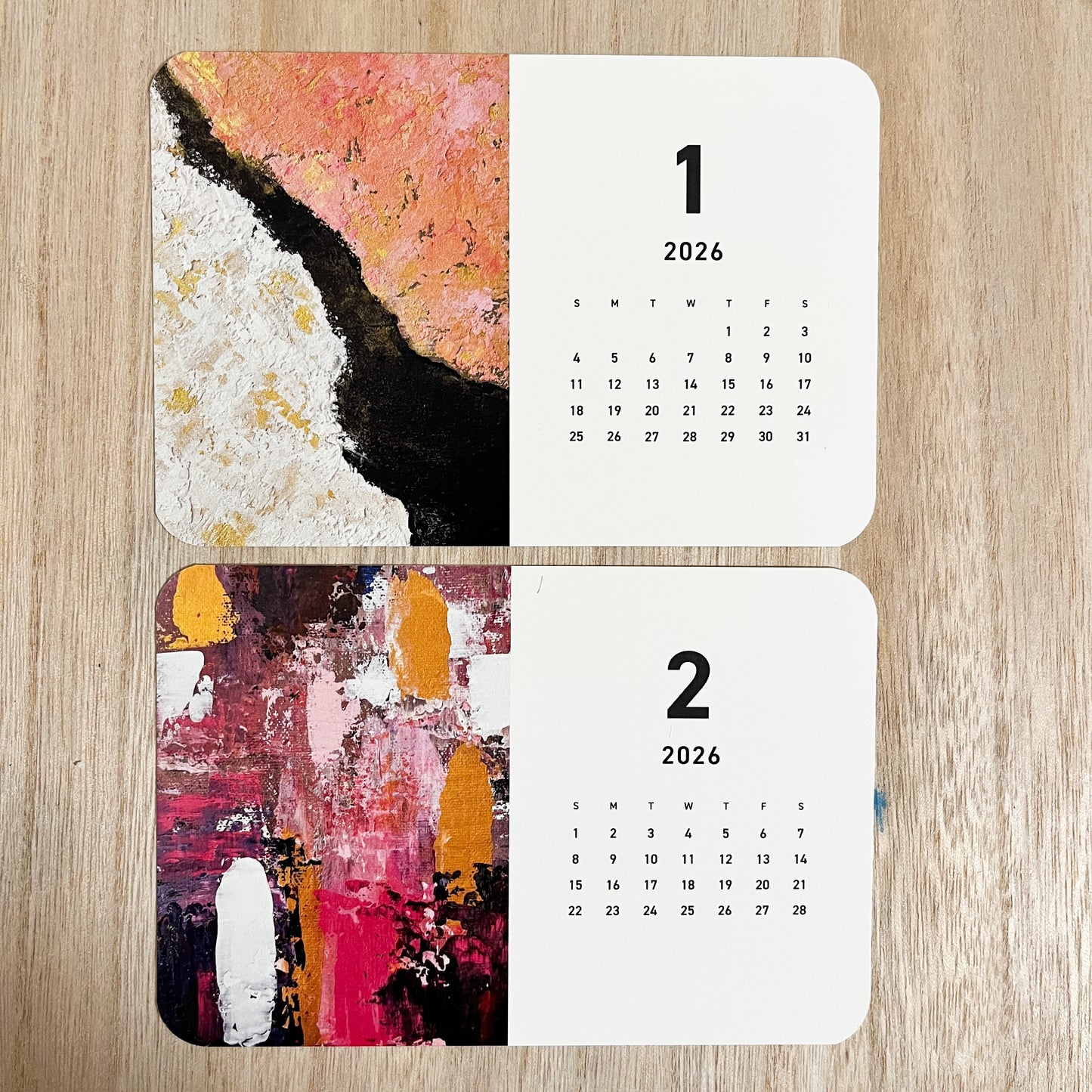 Yuka Mitsufuji 2026 desk calendar showing two months open, featuring vibrant abstract artworks / Yuka Mitsufuji 2026年卓上カレンダー、2ヶ月分見開き、鮮やかな抽象画作品