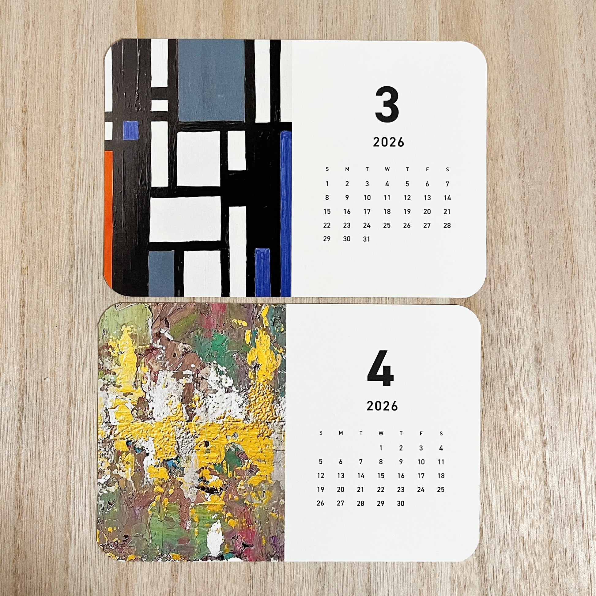 Yuka Mitsufuji 2026 desk calendar showing two months open, featuring vibrant contemporary artworks / Yuka Mitsufuji 2026年卓上カレンダー、2ヶ月分見開き、鮮やかな現代アート作品